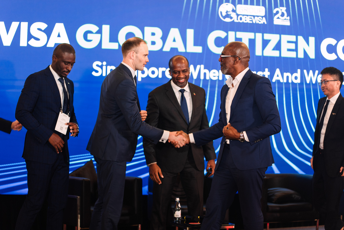 Leaders connect on stage after a featured discussion.